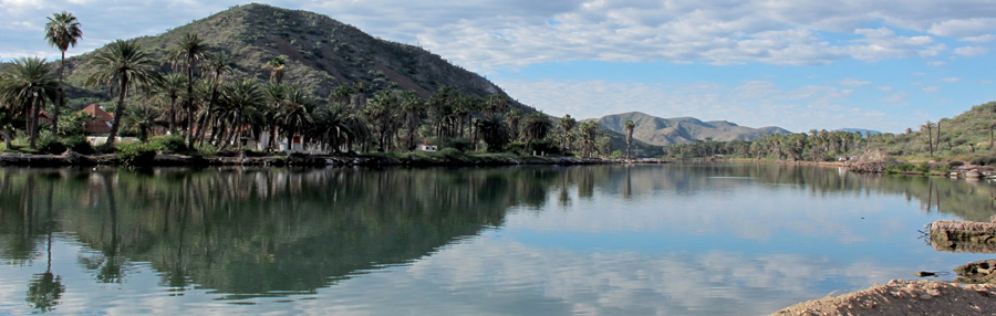 Clouds and hills reflected in the still Rio Mulege