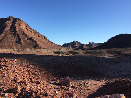 dark reddish volcanic soil and rocks